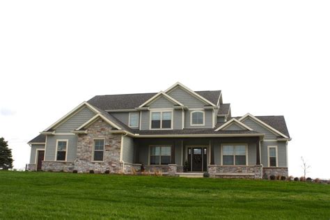 grand ranch style home with green siding, cream trim and stone accents | Green siding, House ...