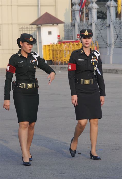 Thai military policewomen make an arrest. "Don't move!" one calls out ...