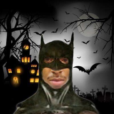 a man wearing a batman mask with bats in the background