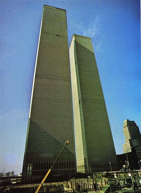 two very tall buildings next to each other on a sunny day with blue sky ...