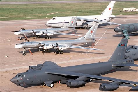 Two Tu-95 bombers and an An-124 transport aircraft of the Russian military are parked next to a ...