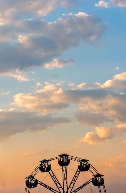 Premium Photo | Sunset with Ferris wheel silhouette