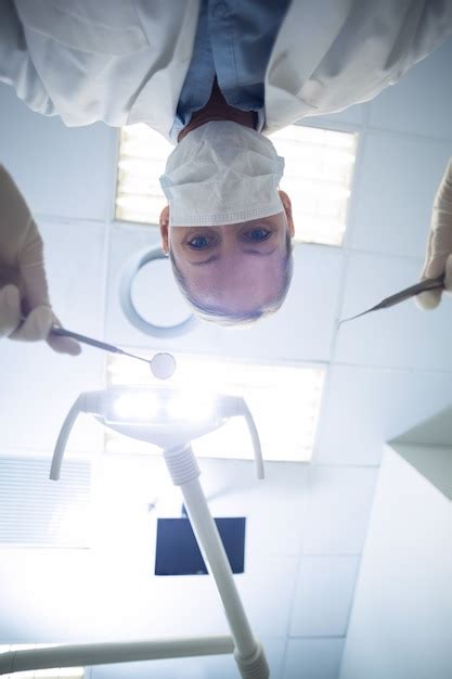 Premium Photo | Female dentist holding dental tools