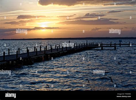 Sunset on the sea and Jetty Stock Photo - Alamy