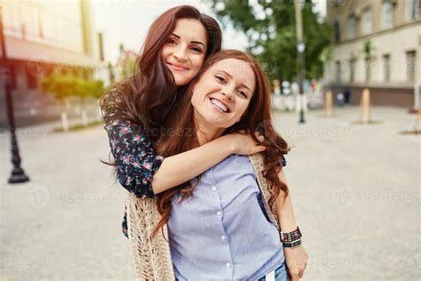 Two cheerful sisters hugging 854820 Stock Photo at Vecteezy