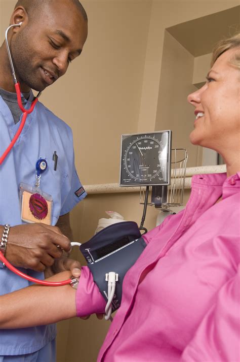 Blood Pressure | Free Stock Photo | A male nurse taking the blood pressure of a woman | # 15413