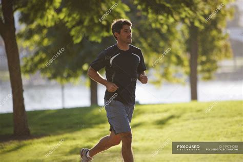 Man jogging in park during daytie — outdoors, Mid Adult - Stock Photo ...