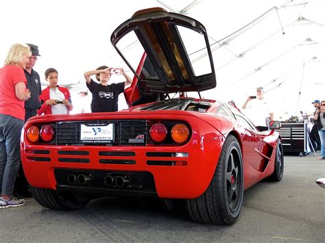 A bright red McLaren F1 in the paddock at Laguna Seca | Mind Over Motor