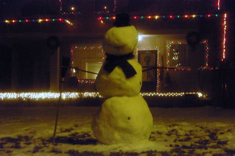 Snowman in the front yard Photograph by Jeff Swan