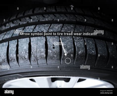 The arrow symbol point to tire tread wear indicator of car tire Stock Photo - Alamy