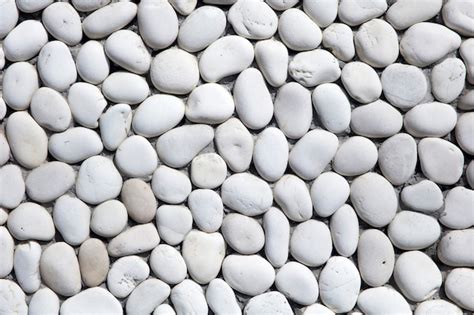 Premium Photo | White pebbles stone texture and background