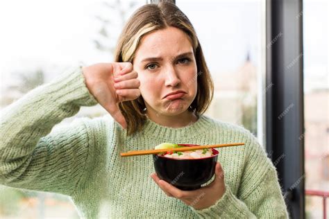 Premium Photo | Pretty young woman eating a ramen chinese noodles bowl house interior design