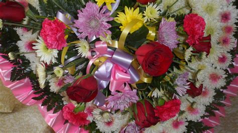 a bouquet of flowers with ribbons and bows