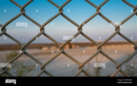 Background image of a garden chain link fence fence Stock Photo - Alamy