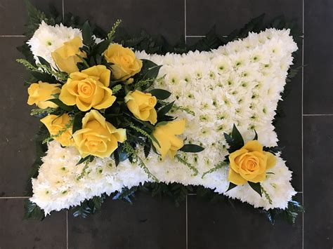 Pillow funeral flowers tribute, white based with yellow rose focal ...