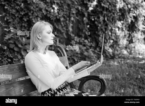 Freelance benefits. Woman with laptop works outdoor, green nature background. Lady freelancer ...