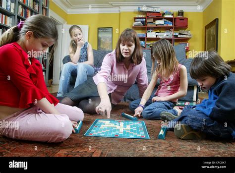 Family at home playing Scrabble board game, United Kingdom Stock Photo ...