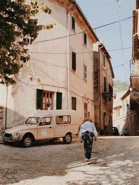 Man Walking Near Beige Truck · Free Stock Photo