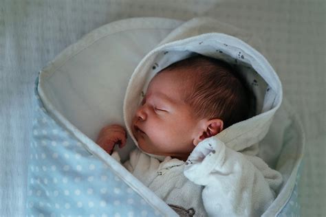Baby in White and Blue Blanket · Free Stock Photo