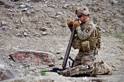 U.S. Army Spc. Sean M. Tallman sets up a 60mm mortar system while on a ...