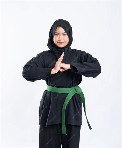 Premium Photo | A hooded woman wearing a pencak silat uniform with a green belt performs ...