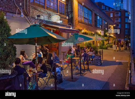 Bars and restaurants at night, Post Alley behind Pike Place Market, Seattle, Washington, USA ...