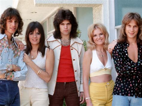 Four Celebrities Posing in Front of a House