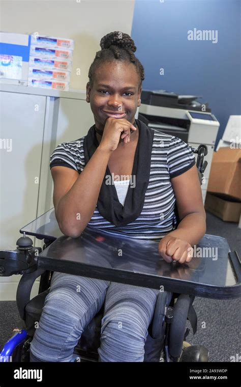 Teen with Cerebral Palsy sitting in office Stock Photo - Alamy