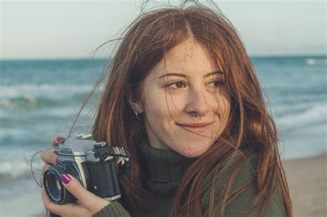 Woman in Black Scarf Holding Black and Silver Dslr Camera · Free Stock Photo