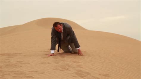 Exhausted Businessman Crawling In The Desert Stock Footage Video 2078975 - Shutterstock