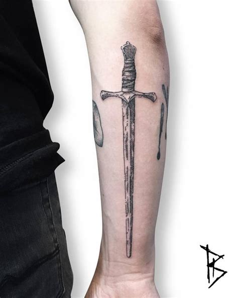 Engraving style sword tattoo on the right forearm.