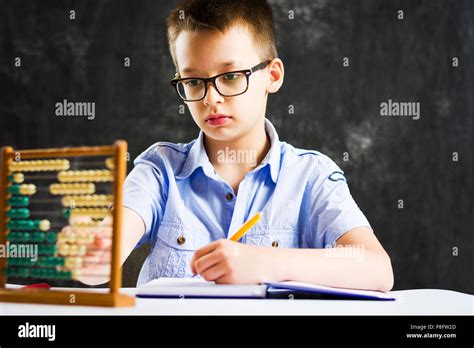 Boy solving math problems at home alone Stock Photo - Alamy