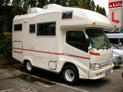 a white motor home parked in a parking lot