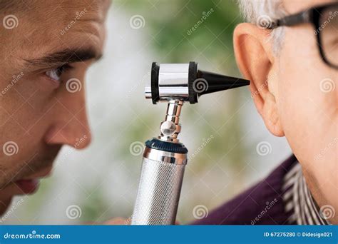 Doctor Performs an Ear Examination Stock Photo - Image of male, clinic ...