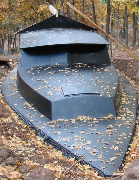 an old boat sitting in the middle of some leaves on the ground and trees behind it