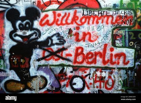 Graffiti on the west side of the Berlin Wall depicts the transition ...