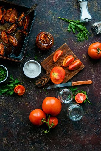 Appetizer Delicacy Preparation Of Dried Tomatoes In A Jar With Spices On A Dark Background Stock ...