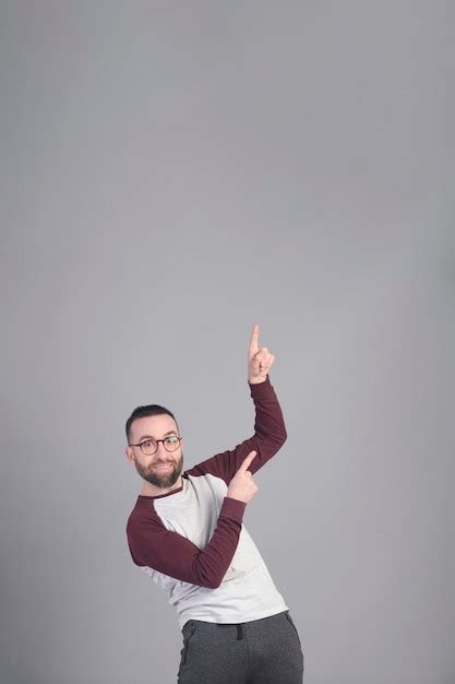 Premium Photo | Young man standing pointing upward to a large copy ...