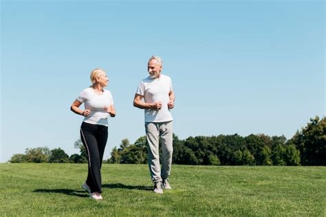 Full shot old people running outdoors Photo | Free Download