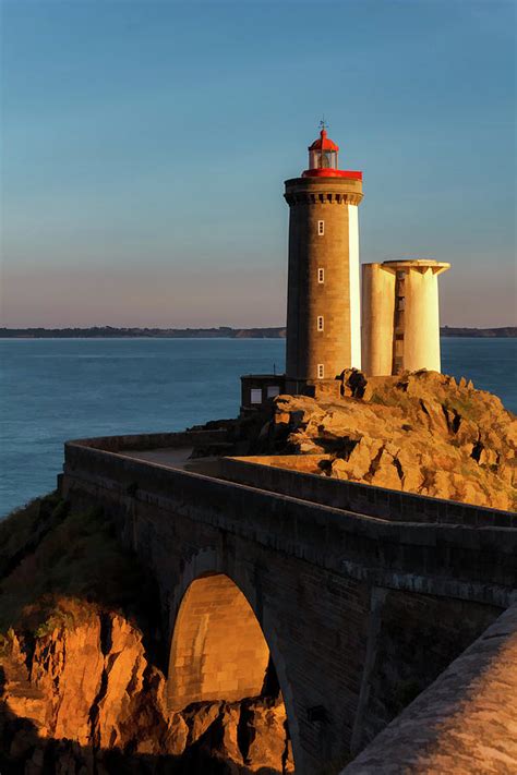 Famous Petit-Minou point lighthouse and bridge on the French brittany coast at sunset Photograph ...