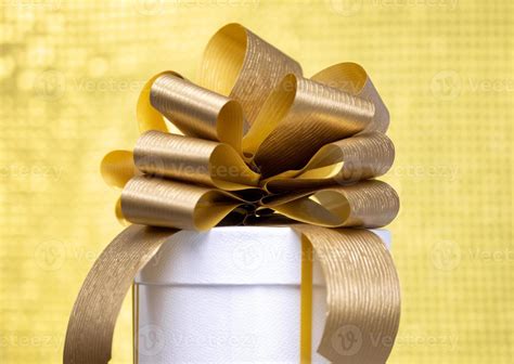 A gift box with a golden bow 21797076 Stock Photo at Vecteezy