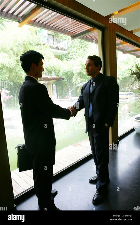 businessmen from different cultures handshaking in hotel Stock Photo - Alamy