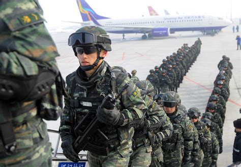 Chinese forces rumble through Uighur-dominated Urumqi in new display | The Japan Times