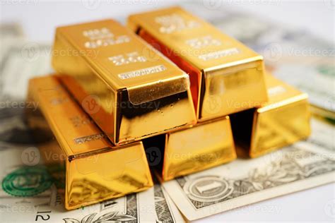 Gold bars on US dollar banknote money, finance trading investment business currency concept ...