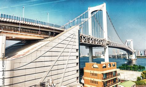 Rainbow Bridge in Odaiba with river and buildings - Tokyo - Japa Stock ...