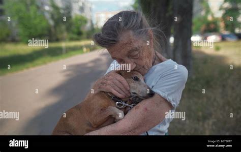 Animal theme is a lonely old woman best friend. Caucasian 90 years old senior female is happy to ...