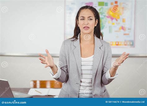 Pretty Teacher Teaching in a Classroom Stock Photo - Image of profession, brown: 58116674