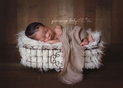 Gorgeous African American baby boy sleeping on fur in a basket. Newborn ...