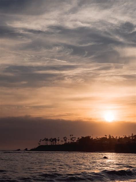 Silhouette of Beach during Sunset · Free Stock Photo