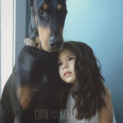 White Wolf : This little girl and her Doberman are everything a canine ...